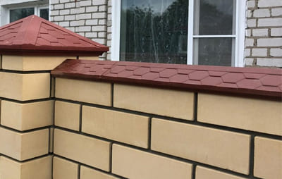 Оформление забора с помощью парапета и колпаков